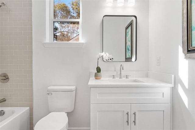 full bathroom featuring tiled shower / bath combo, vanity, and toilet