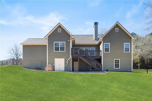 back of property featuring stairs, a lawn, a chimney, and fence