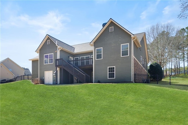 back of house featuring fence, stairway, a lawn, and a wooden deck