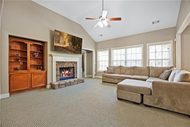 carpeted living room featuring baseboards, a fireplace, visible vents, and a healthy amount of sunlight