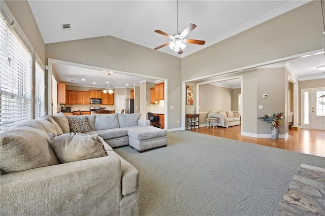 living room with baseboards, light wood-type flooring, visible vents, and crown molding