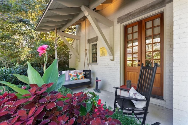 property entrance featuring french doors and a porch