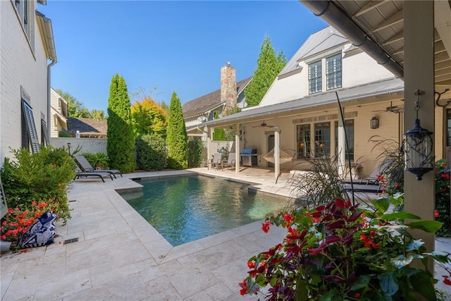 view of pool featuring ceiling fan, area for grilling, and a patio