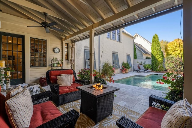 view of patio / terrace featuring a fenced in pool and an outdoor living space with a fire pit