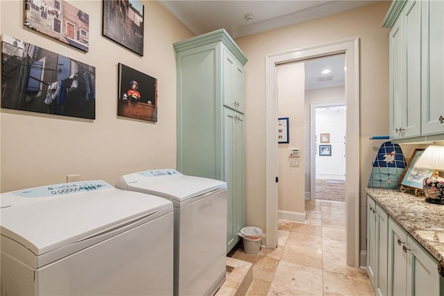 laundry room with cabinets, ornamental molding, and washer and clothes dryer