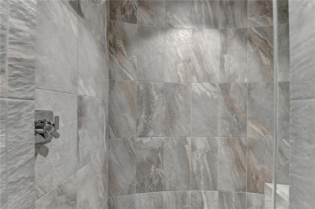 interior details featuring tiled shower