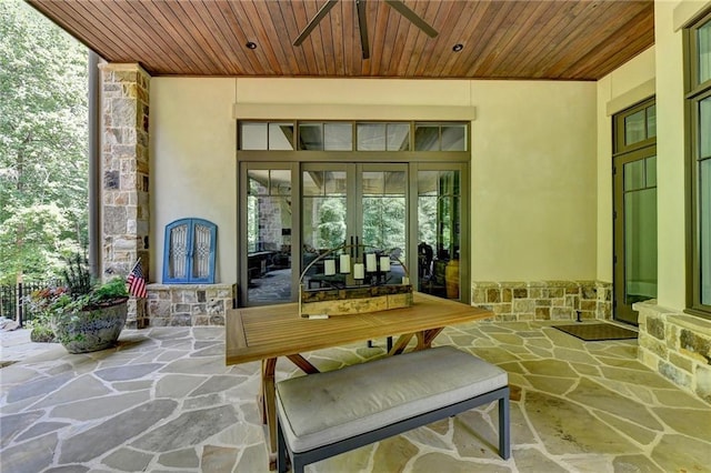 property entrance with a patio area, ceiling fan, and french doors