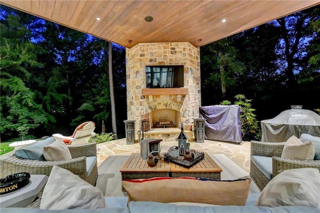 view of patio with area for grilling and an outdoor living space with a fireplace