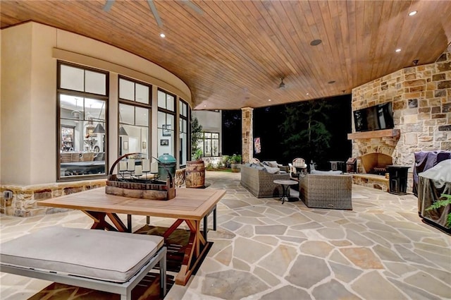 view of patio featuring an outdoor living space with a fireplace