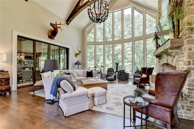 living room featuring high vaulted ceiling, a healthy amount of sunlight, and dark wood-type flooring