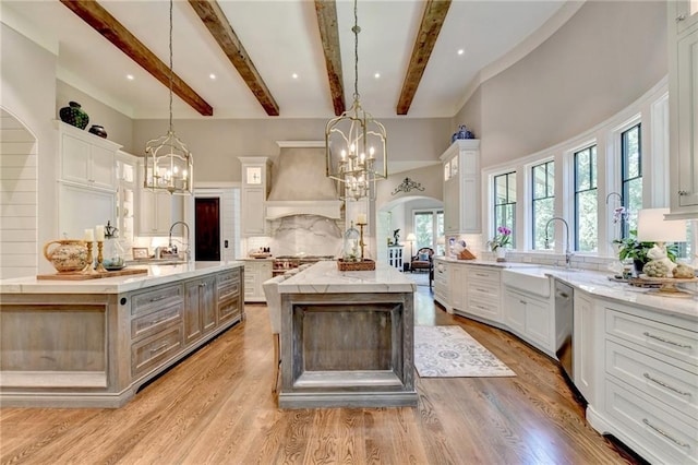 kitchen featuring pendant lighting, a large island, and custom range hood