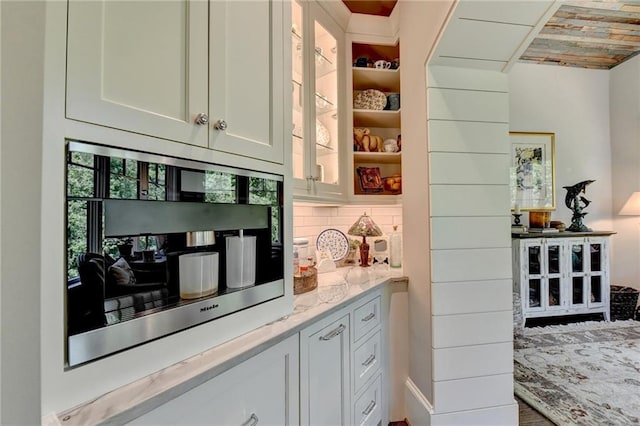 bar featuring white cabinets, wooden ceiling, light stone countertops, and decorative backsplash