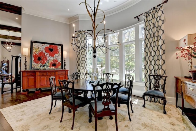 dining area featuring a notable chandelier, crown molding, and wood-type flooring