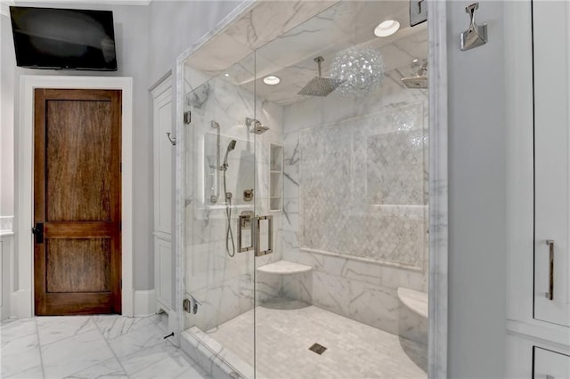 bathroom featuring a shower with door