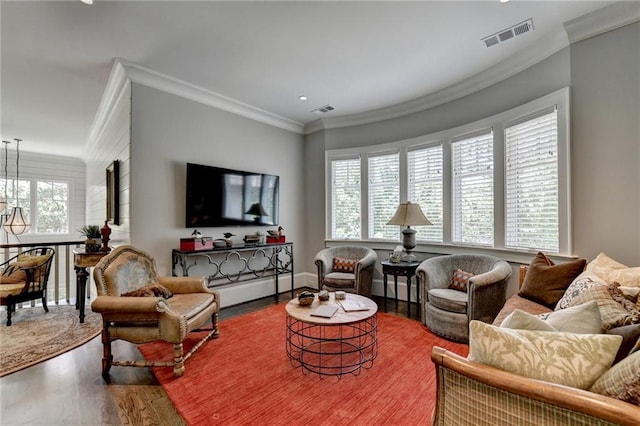 living room featuring plenty of natural light, hardwood / wood-style floors, and ornamental molding