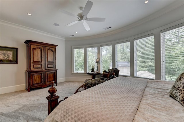 carpeted bedroom featuring ceiling fan and ornamental molding