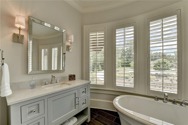 bathroom featuring vanity, a bathtub, and ornamental molding