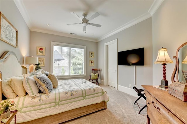 carpeted bedroom with ceiling fan and ornamental molding