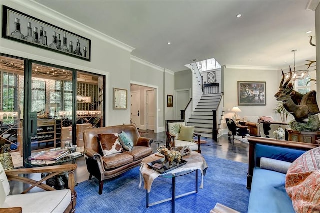 living room with hardwood / wood-style flooring, a chandelier, and ornamental molding