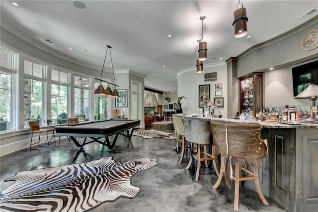 playroom with bar area, pool table, ornamental molding, and concrete flooring