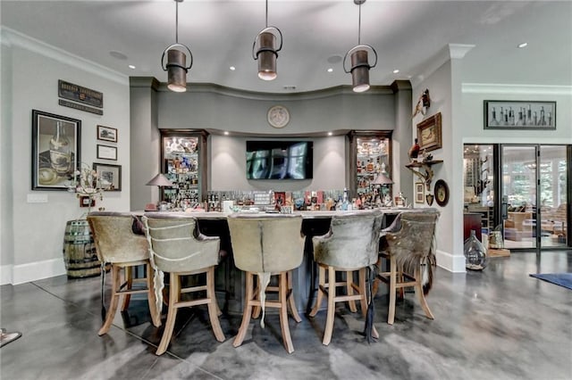 bar featuring pendant lighting and crown molding