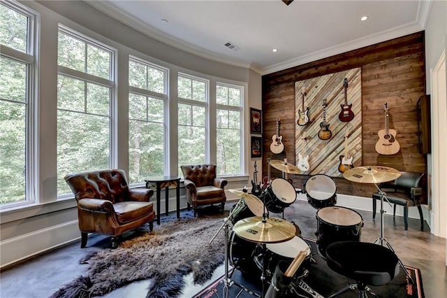 living area featuring concrete floors, wood walls, and crown molding