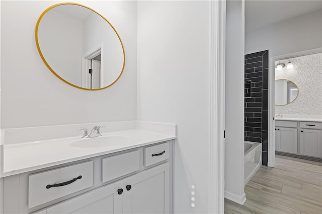 bathroom featuring hardwood / wood-style floors, vanity, and tub / shower combination