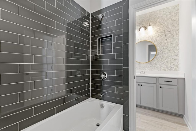 bathroom with vanity and tiled shower / bath