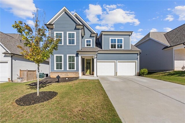 view of front of home featuring a front yard and a garage