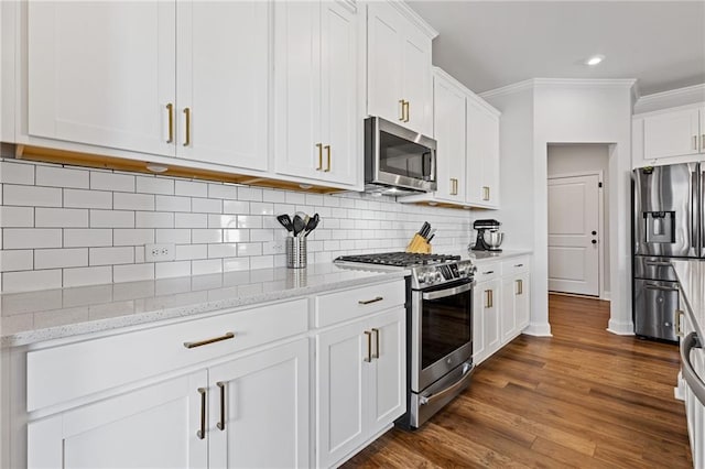 kitchen with light stone countertops, stainless steel appliances, tasteful backsplash, dark hardwood / wood-style floors, and white cabinets