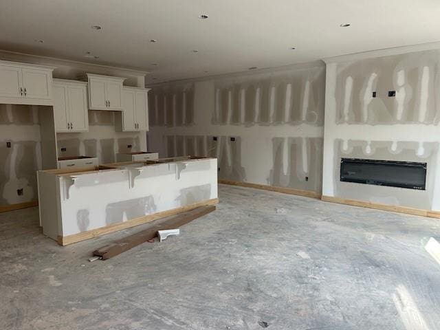 kitchen with a kitchen breakfast bar and white cabinets