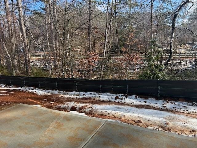 yard layered in snow featuring a patio area