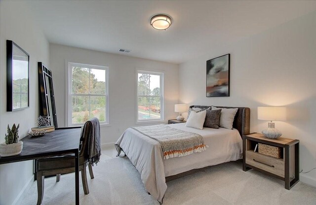 bedroom featuring light carpet and ceiling fan