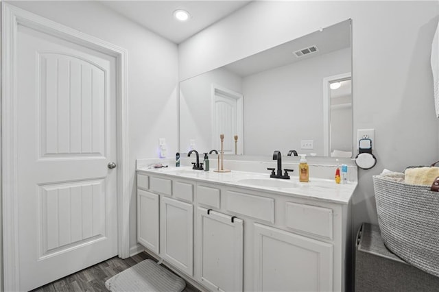 4989 Fawnwood Dr, Gainesville, GA 30504 - full bath featuring wood finished floors, double vanity, and recessed lighting
