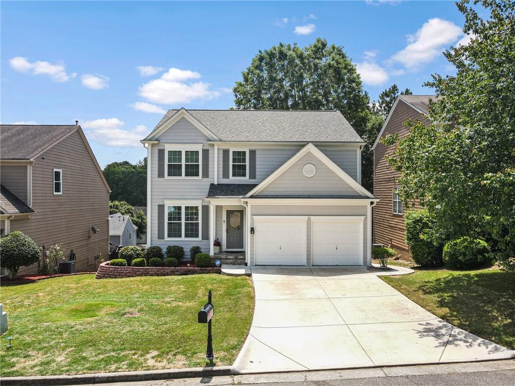 205 Lembeth Ct, Alpharetta, GA 30004 - traditional home featuring driveway, a garage, and a front yard