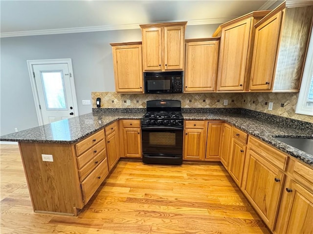8967 Midlothian Ct, Winston, GA 30187 - kitchen with black appliances, a peninsula, ornamental molding, light wood-type flooring, and backsplash