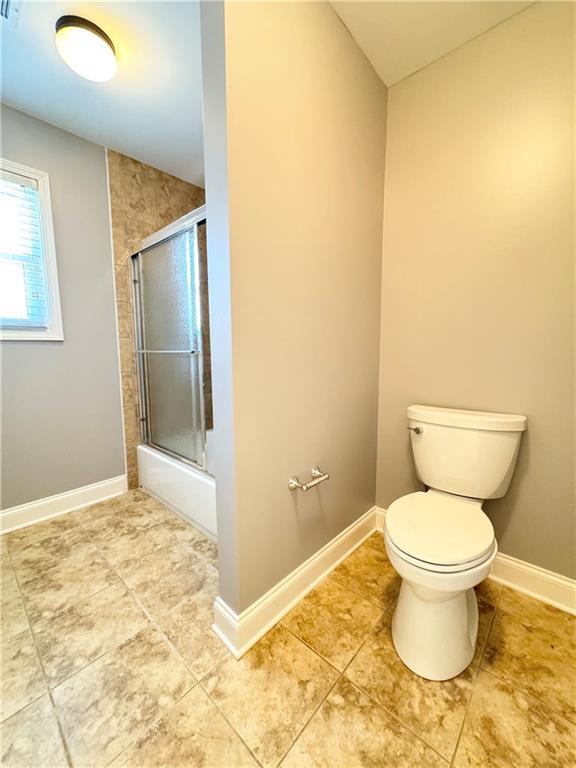8967 Midlothian Ct, Winston, GA 30187 - bathroom featuring toilet, baseboards, and tile patterned floors