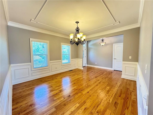 8967 Midlothian Ct, Winston, GA 30187 - unfurnished room with a chandelier, ornamental molding, wainscoting, light wood-type flooring, and a decorative wall