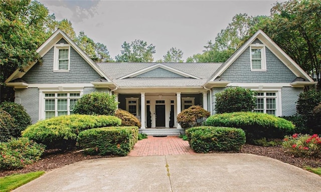 craftsman-style home with brick siding and a porch