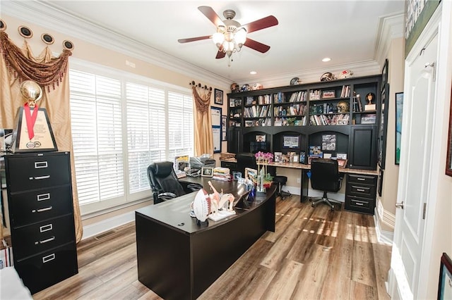 home office with light wood finished floors, a ceiling fan, and ornamental molding