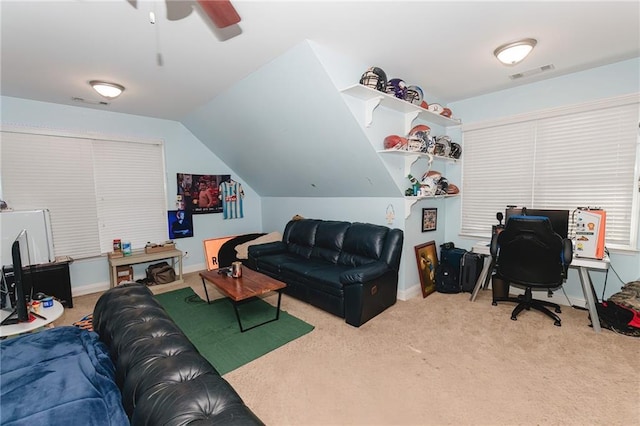 living room featuring a ceiling fan, lofted ceiling, carpet, and visible vents