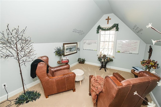 living area featuring baseboards, lofted ceiling, and carpet