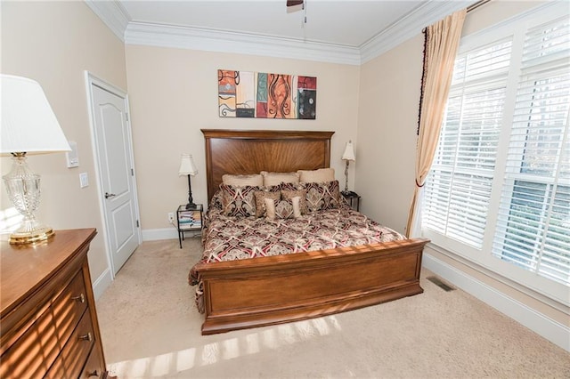 bedroom featuring visible vents, crown molding, baseboards, light colored carpet, and a ceiling fan