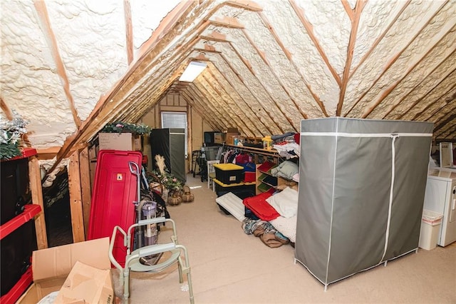 unfinished attic with washer and clothes dryer