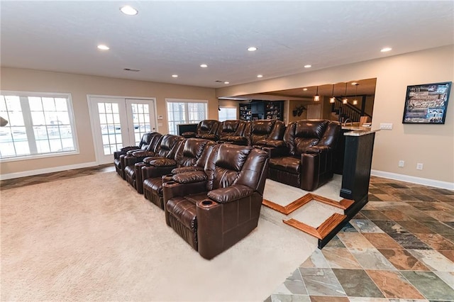 cinema room featuring recessed lighting, french doors, baseboards, and stone finish floor