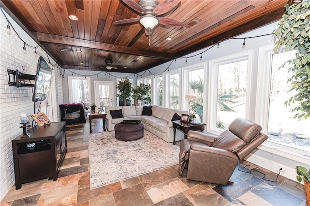 sunroom featuring wood ceiling and ceiling fan