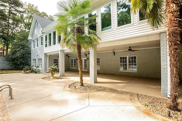 rear view of property featuring a patio area, brick siding, and ceiling fan