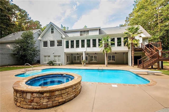 view of pool with stairs, a patio, a deck, and a ceiling fan