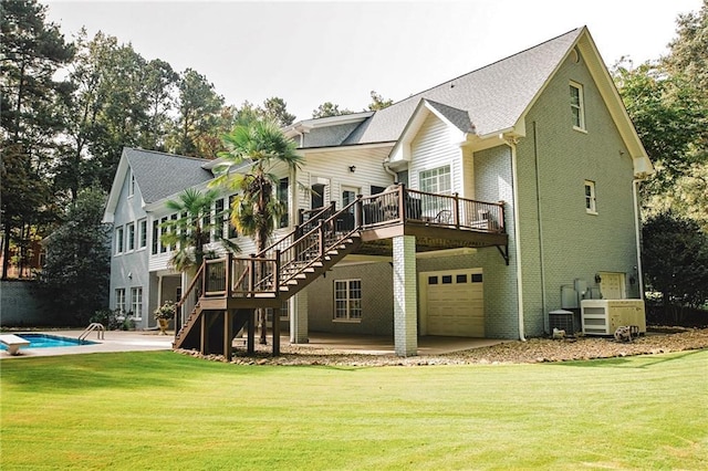 back of property with stairway, a wooden deck, a yard, a patio area, and brick siding