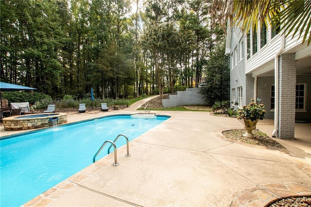 view of swimming pool featuring a patio area and a pool with connected hot tub